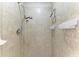 Modern shower with updated fixtures and tile, plus convenient storage shelves at 7315 River Hammock Dr # 101, Bradenton, FL 34212