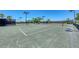 Well-maintained tennis courts providing ample space for recreational play, shaded seating, and professional-grade playing surfaces at 7315 River Hammock Dr # 101, Bradenton, FL 34212