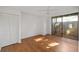 Bright bedroom featuring hardwood floors and sliding glass doors at 754 Pine Run Dr # 754, Osprey, FL 34229