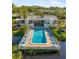 Aerial image of the community pool, lounge chairs and inviting blue water at 754 Pine Run Dr # 754, Osprey, FL 34229