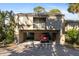 Inviting two-story townhouse with covered parking and balcony overlooking lush tropical landscaping at 754 Pine Run Dr # 754, Osprey, FL 34229
