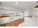 Bright kitchen featuring white cabinetry, modern appliances, terracotta floors, and beach-themed decor at 754 Pine Run Dr # 754, Osprey, FL 34229