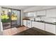 Bright kitchen featuring white cabinetry, modern appliances, terracotta floors and access to the outdoor area at 754 Pine Run Dr # 754, Osprey, FL 34229