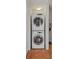 A stacked white washer and dryer set is in a laundry closet with ceramic tile flooring at 754 Pine Run Dr # 754, Osprey, FL 34229