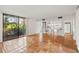 Open-concept living area with ceramic tile floors seamlessly connects to a modern kitchen with bar seating at 754 Pine Run Dr # 754, Osprey, FL 34229