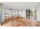Bright room with terracotta tile and sliding doors to an outdoor area adjacent to the all-white kitchen at 754 Pine Run Dr # 754, Osprey, FL 34229