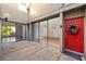 Private patio area with tiled floors and a red front door at 754 Pine Run Dr # 754, Osprey, FL 34229