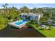 A relaxing pool surrounded by lounge chairs next to a pond offering residents a relaxing area at 754 Pine Run Dr # 754, Osprey, FL 34229