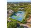Aerial view of well-maintained tennis courts surrounded by lush greenery and community buildings at 754 Pine Run Dr # 754, Osprey, FL 34229