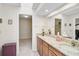 Spacious bathroom with granite counters and doorways to a walk-in closet at 7817 Pine Trace Dr # 15, Sarasota, FL 34243