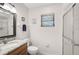 Neutral bathroom with granite counters, modern lighting, and tiled shower at 7817 Pine Trace Dr # 15, Sarasota, FL 34243