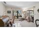 Bedroom features a roll-top desk, sliding glass doors, and neutral carpeting at 7817 Pine Trace Dr # 15, Sarasota, FL 34243