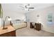 Comfortable bedroom with neutral carpet, ceiling fan, and natural light from the window at 7817 Pine Trace Dr # 15, Sarasota, FL 34243