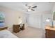 Bright bedroom features a ceiling fan, closet, desk, and neutral carpeting at 7817 Pine Trace Dr # 15, Sarasota, FL 34243