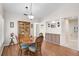 Bright dining room featuring laminate wood flooring, dining table with chairs and decorative china cabinet at 7817 Pine Trace Dr # 15, Sarasota, FL 34243