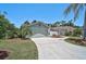 Charming single-story home with landscaped front yard, palm tree, attached garage and long concrete driveway at 7817 Pine Trace Dr # 15, Sarasota, FL 34243