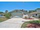 Charming single-story home with landscaped front yard, palm tree, attached garage and concrete driveway at 7817 Pine Trace Dr # 15, Sarasota, FL 34243