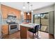 Modern kitchen has stainless appliances, granite counters, and an island with bar seating at 7817 Pine Trace Dr # 15, Sarasota, FL 34243