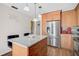 Bright kitchen with stainless appliances, center island, granite countertops and pendant lighting at 7817 Pine Trace Dr # 15, Sarasota, FL 34243