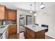 Well-lit kitchen with granite countertops, center island, and sliding glass door access to the patio at 7817 Pine Trace Dr # 15, Sarasota, FL 34243