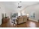 Inviting living room featuring vaulted ceiling, wood laminate flooring, and access to an outdoor patio and garden at 7817 Pine Trace Dr # 15, Sarasota, FL 34243