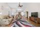 Bright living room with hardwood flooring, neutral wall color, vaulted ceiling and comfortable furniture at 7817 Pine Trace Dr # 15, Sarasota, FL 34243