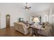 Inviting living room featuring vaulted ceiling, wood laminate flooring, and access to an outdoor patio at 7817 Pine Trace Dr # 15, Sarasota, FL 34243