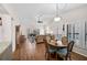 Cozy living room features wood floors, vaulted ceilings, and bright, natural light from the patio doors at 7817 Pine Trace Dr # 15, Sarasota, FL 34243