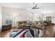 Inviting living room with vaulted ceiling, neutral walls, wood laminate flooring and comfortable seating at 7817 Pine Trace Dr # 15, Sarasota, FL 34243
