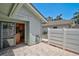 Exterior patio area with brick pavers and access to the kitchen through a sliding glass door at 7817 Pine Trace Dr # 15, Sarasota, FL 34243