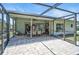 Screened-in patio with brick flooring, providing a bug-free outdoor space for dining and relaxation at 7817 Pine Trace Dr # 15, Sarasota, FL 34243