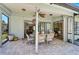 Covered patio featuring brick flooring and a cozy dining area, perfect for outdoor entertaining at 7817 Pine Trace Dr # 15, Sarasota, FL 34243