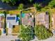 Aerial view of the property, showcasing its beautiful backyard pool and surrounding landscape at 8304 Fishhawk Ave, New Port Richey, FL 34653