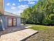 This home has a backyard view with a stone patio, and a river surrounded by trees at 8304 Fishhawk Ave, New Port Richey, FL 34653