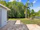 Backyard view with patio, and scenic wooded area by the water offers privacy and a relaxing atmosphere at 8304 Fishhawk Ave, New Port Richey, FL 34653