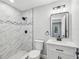 Updated bathroom with tiled shower, modern vanity, and sleek fixtures offering a clean aesthetic at 8304 Fishhawk Ave, New Port Richey, FL 34653