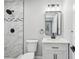 Modern bathroom featuring a shower with beautiful tile surround, black fixtures and vanity at 8304 Fishhawk Ave, New Port Richey, FL 34653