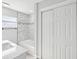 Bathroom with double-door closet, marble countertop, bathtub and modern fixtures at 8304 Fishhawk Ave, New Port Richey, FL 34653