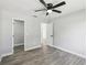 Spacious bedroom with wood flooring, a fan, and neutral paint at 8304 Fishhawk Ave, New Port Richey, FL 34653