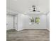 Bright bedroom with modern lighting, neutral walls, wood floors, and a large window with a pleasant view at 8304 Fishhawk Ave, New Port Richey, FL 34653