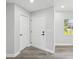 Clean entryway with modern doors, neutral walls, wood floors, and natural light from a nearby window at 8304 Fishhawk Ave, New Port Richey, FL 34653