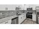 Modern kitchen boasting stainless steel appliances, granite countertops, and a blue tile backsplash at 8304 Fishhawk Ave, New Port Richey, FL 34653