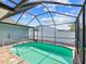 This in ground pool is surrounded by a screened patio, offering both privacy and a space to relax at 8304 Fishhawk Ave, New Port Richey, FL 34653