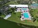 Birds-eye-view of community clubhouse and pools overlooking a body of water at 8400 Princess Ct, Palmetto, FL 34221