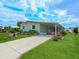 Charming home featuring a covered carport, manicured lawn, complemented by flower beds at 8400 Princess Ct, Palmetto, FL 34221
