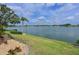 Lush backyard featuring manicured lawn and serene lake views from the property at 8439 Imperial Cir, Palmetto, FL 34221