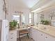Neutral bathroom featuring white vanity, makeup counter, stool, and tiled floors at 8439 Imperial Cir, Palmetto, FL 34221