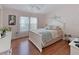 Bedroom with hardwood floors, a queen sized bed, a dresser, and closet space at 8439 Imperial Cir, Palmetto, FL 34221