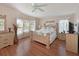 Bright bedroom featuring wood-look floors, natural light, and light wood furniture at 8439 Imperial Cir, Palmetto, FL 34221
