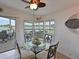 Cozy breakfast nook with lake views, a glass table, and stylish seating at 8439 Imperial Cir, Palmetto, FL 34221